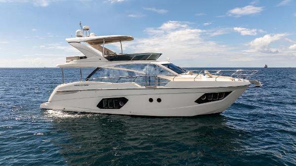 Absolute Flybridge 2020 Absolute Flybridge yacht cruising on open sea under clear skies.