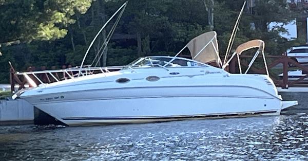 Sea Ray 260 Sundancer 2001 Sea Ray 260 Sundancer boat docked on a calm lake.