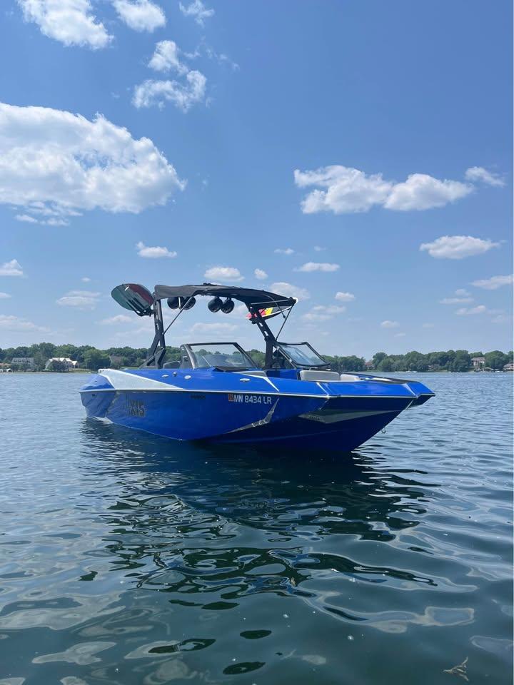 Axis A24 2018 Axis A24 boat on a sunny lake with clear skies.