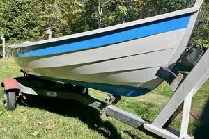 Hylan Beach Pea Rowing-Sailing Peapod 2022 Hylan Beach Pea rowing boat on trailer, blue and white design, outdoors.