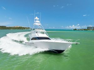 Viking 56 Convertible 2005 Viking 56 Convertible yacht cruising on turquoise waters under clear blue skies.