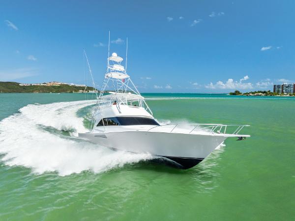 Viking 56 Convertible 2005 Viking 56 Convertible yacht cruising on turquoise waters under clear blue skies.