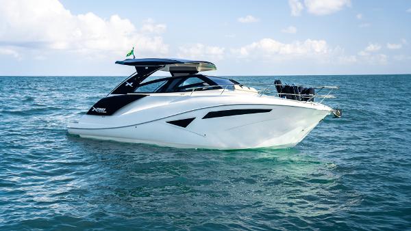 NX Boats NX 360 SPORT COUPE 2025 NX Boats NX360 Sport Coupe cruising on open water under a clear sky.