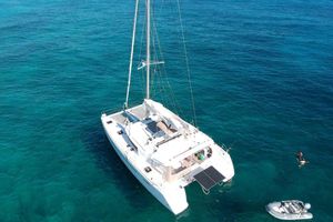 Lagoon 450 F Aerial view of 2016 Lagoon 450 F catamaran sailing on clear blue ocean waters.