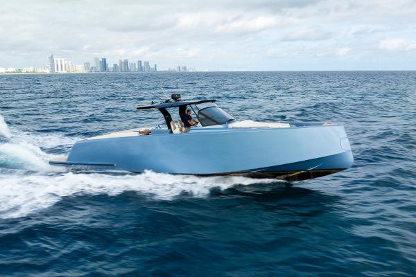 Pardo Yachts 50 2023 Pardo Yachts 50 cruising on open sea with city skyline in background.