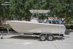 Sailfish 220 CC 2023 Sailfish 220 CC boat on trailer, parked outdoors with trees in the background.