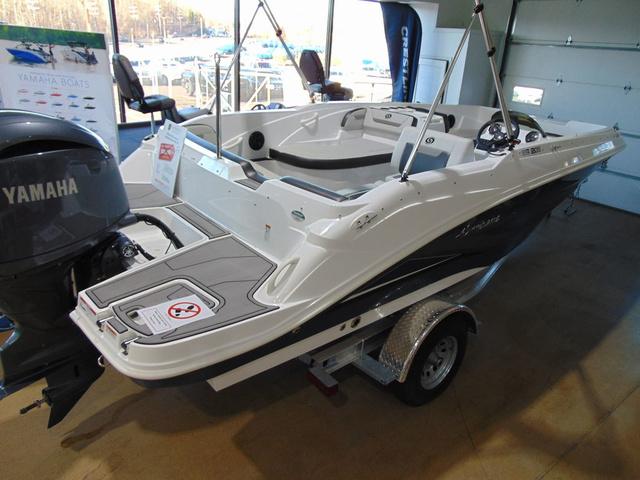 Hurricane SunDeck Sport 205 OB 2024 Hurricane SunDeck Sport 205 OB boat displayed indoors on a trailer.