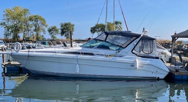 Sea Ray 330 Sundancer 1993 Sea Ray 330 Sundancer docked at a marina, surrounded by calm water and trees.