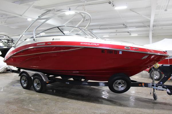 Yamaha Boats 242 Limited S 2014 Yamaha Boats 242 LTD S in red on a trailer, displayed indoors.