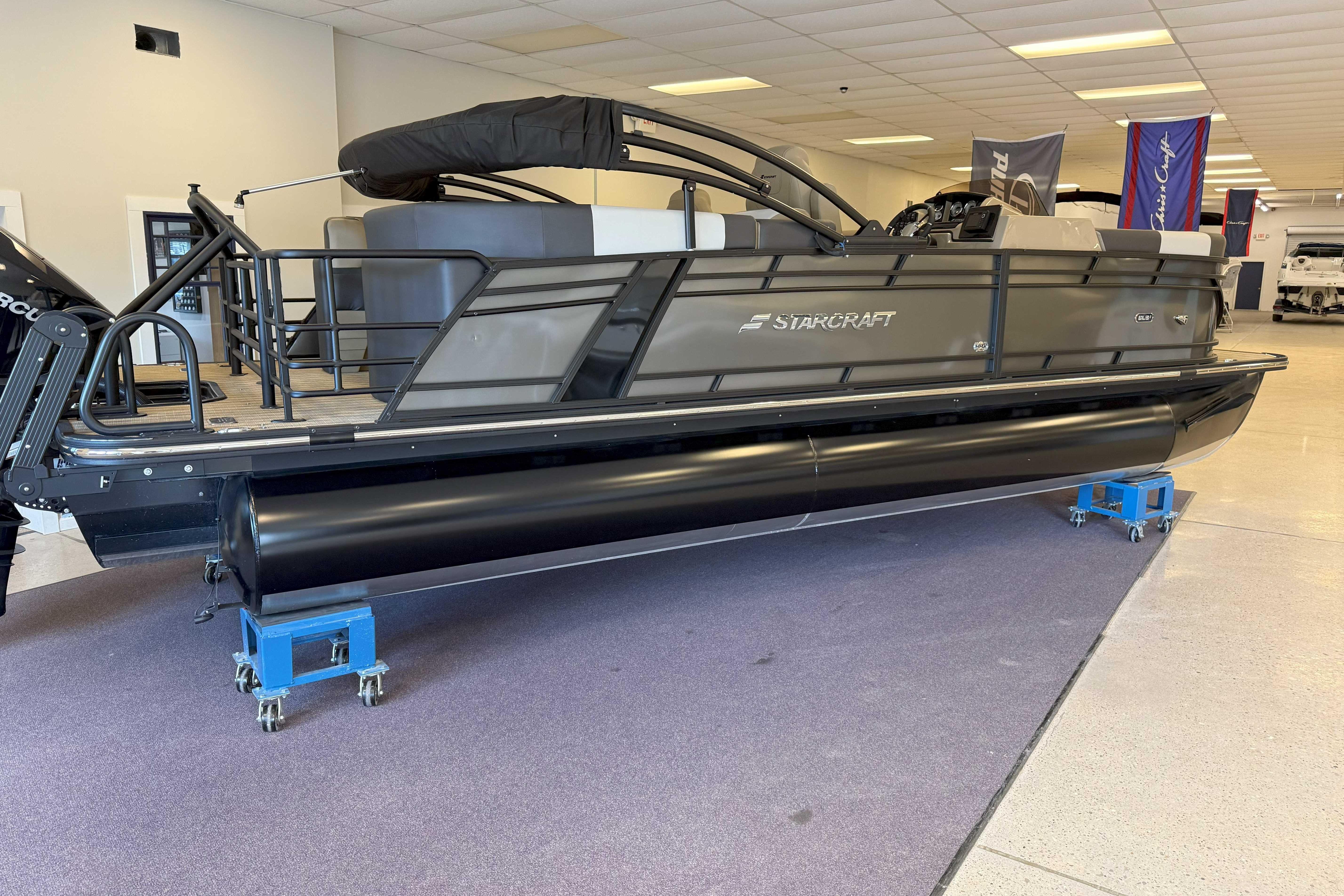 Starcraft SLS 3 2024 Starcraft SLS 3 pontoon boat displayed indoors, featuring sleek design and modern amenities.