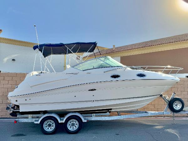 Sea Ray 240 Sundancer 2011 Sea Ray 240 Sundancer boat on trailer, parked outdoors.