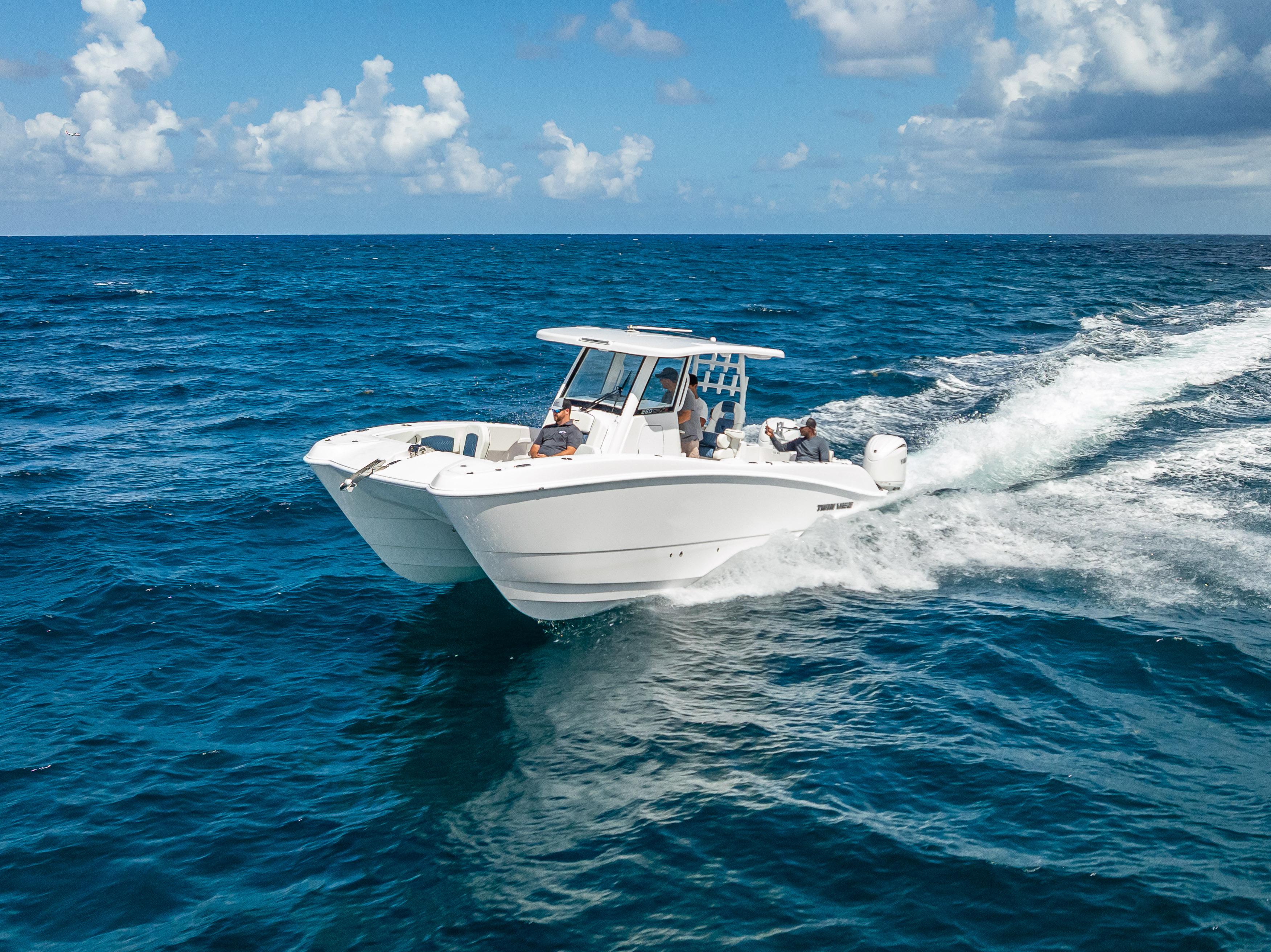 Twin Vee 260 GFX2 CC 2026 Twin Vee 260 GFX2 CC cruising on open ocean under clear skies.
