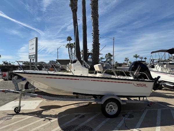 Boston Whaler 150 Montauk 2025 Boston Whaler 150 Montauk boat on trailer, parked outdoors under clear sky.