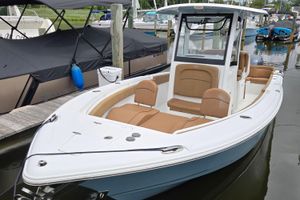 Sea Hunt Ultra 265 SE 2022 Sea Hunt Ultra 265 SE boat docked, featuring sleek design and comfortable seating.