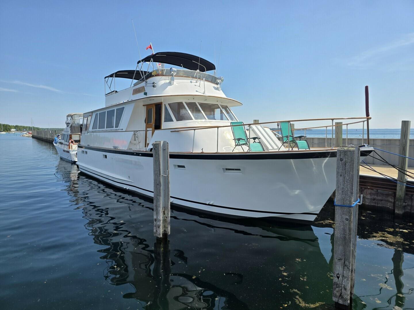 Chris-Craft Roamer 60 1976 Chris-Craft Roamer 60 yacht docked in a serene marina setting.