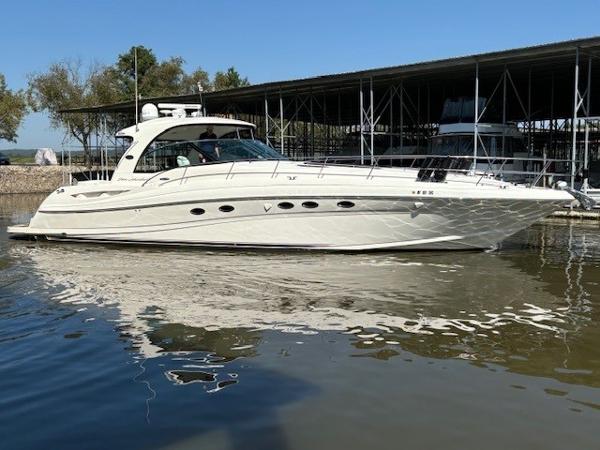 Sea Ray 500 Sundancer 2005 Sea Ray 500 Sundancer yacht docked in a marina, reflecting on calm water.
