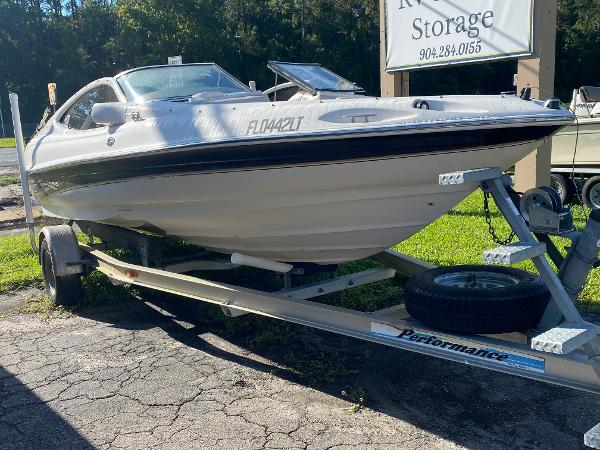 Regal 1900 LSR 2002 Regal 1900 LSR boat on trailer, parked outdoors near storage facility.