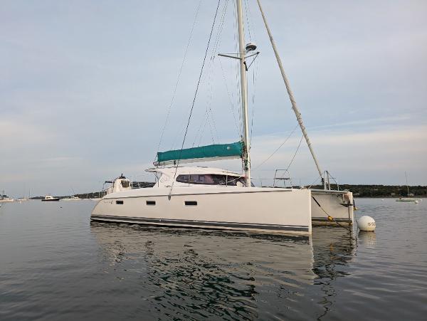 Nautitech 402 Nautitech 402 catamaran, 2011 model, anchored on calm water with a green sail cover.