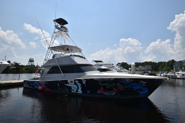 Viking 50 Convertible 1997 Viking 50 Convertible yacht with custom hull art docked at marina.
