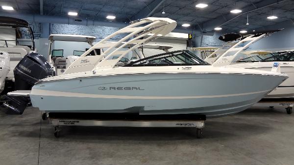 Regal LX2 2025 Regal LX2 boat in showroom, light blue hull, sleek design.