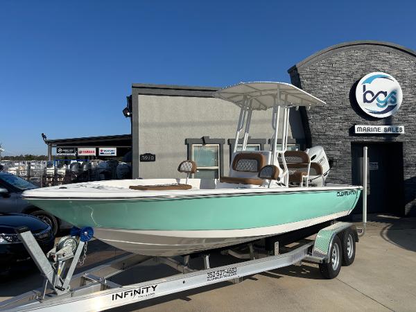 Clearwater 21 Bay 2024 Clearwater 21 Bay boat on trailer at marine sales dealership.