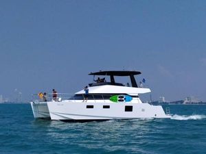 Custom Floeth powercat Custom Floeth Powercat 2020 cruising on blue ocean with people on deck.