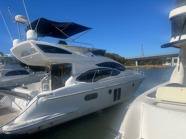 Azimut 40 Flybridge 2013 Azimut 40 Flybridge yacht docked in marina under clear blue sky.