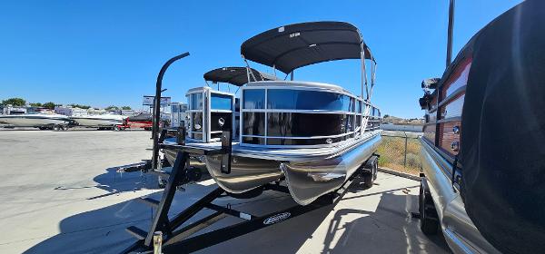 South Bay 224FCRLE 2025 South Bay 224FCRLE pontoon boat on trailer in outdoor lot.