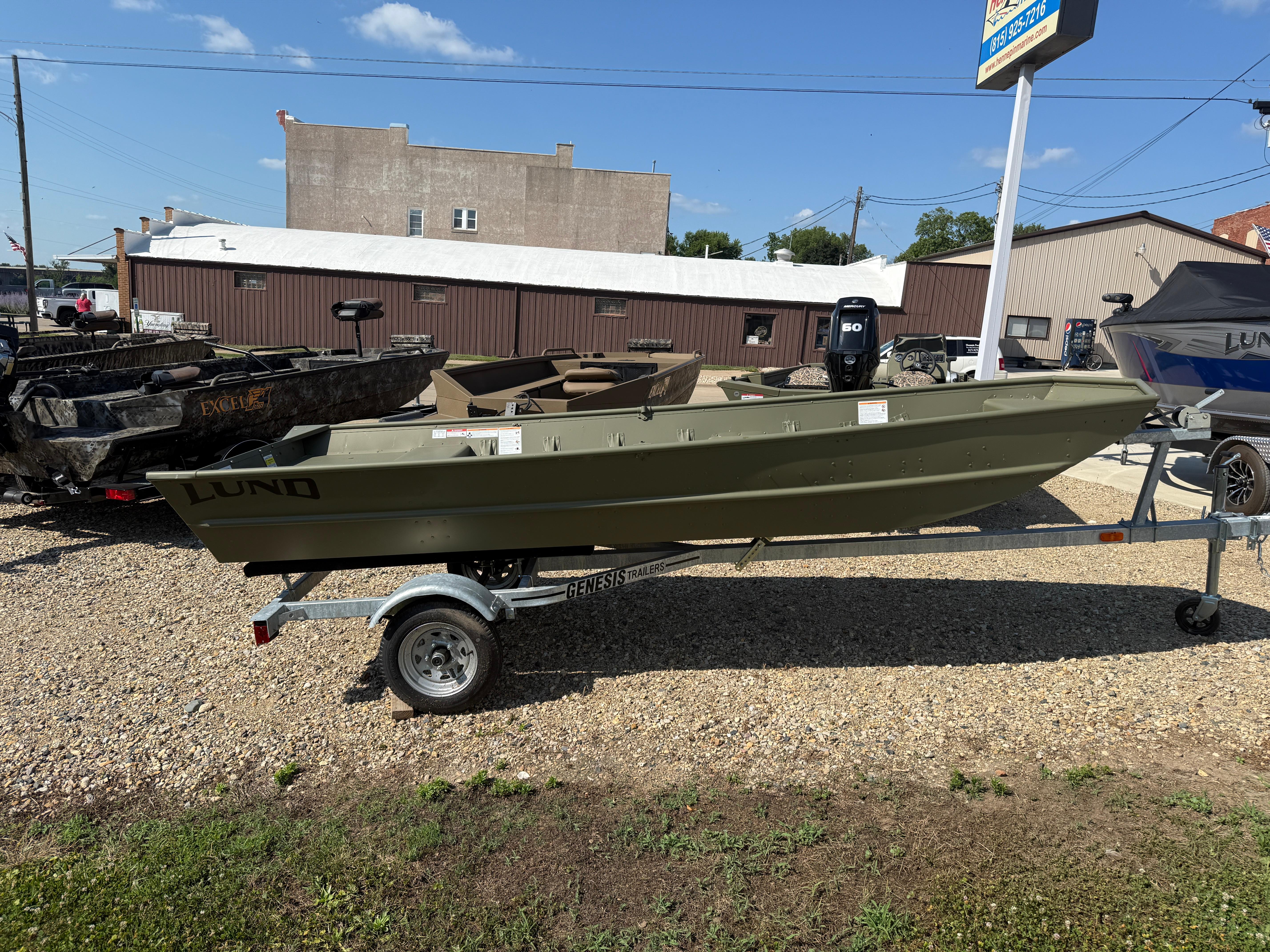 Lund 1440M 2025 Lund 1440M boat on trailer in outdoor dealership lot.