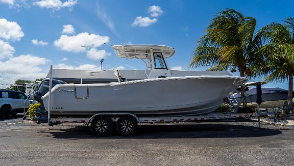Tidewater 282cc Adventure Bluewater 2023 Tidewater 282cc Adventure Bluewater boat on trailer, parked under a sunny sky.