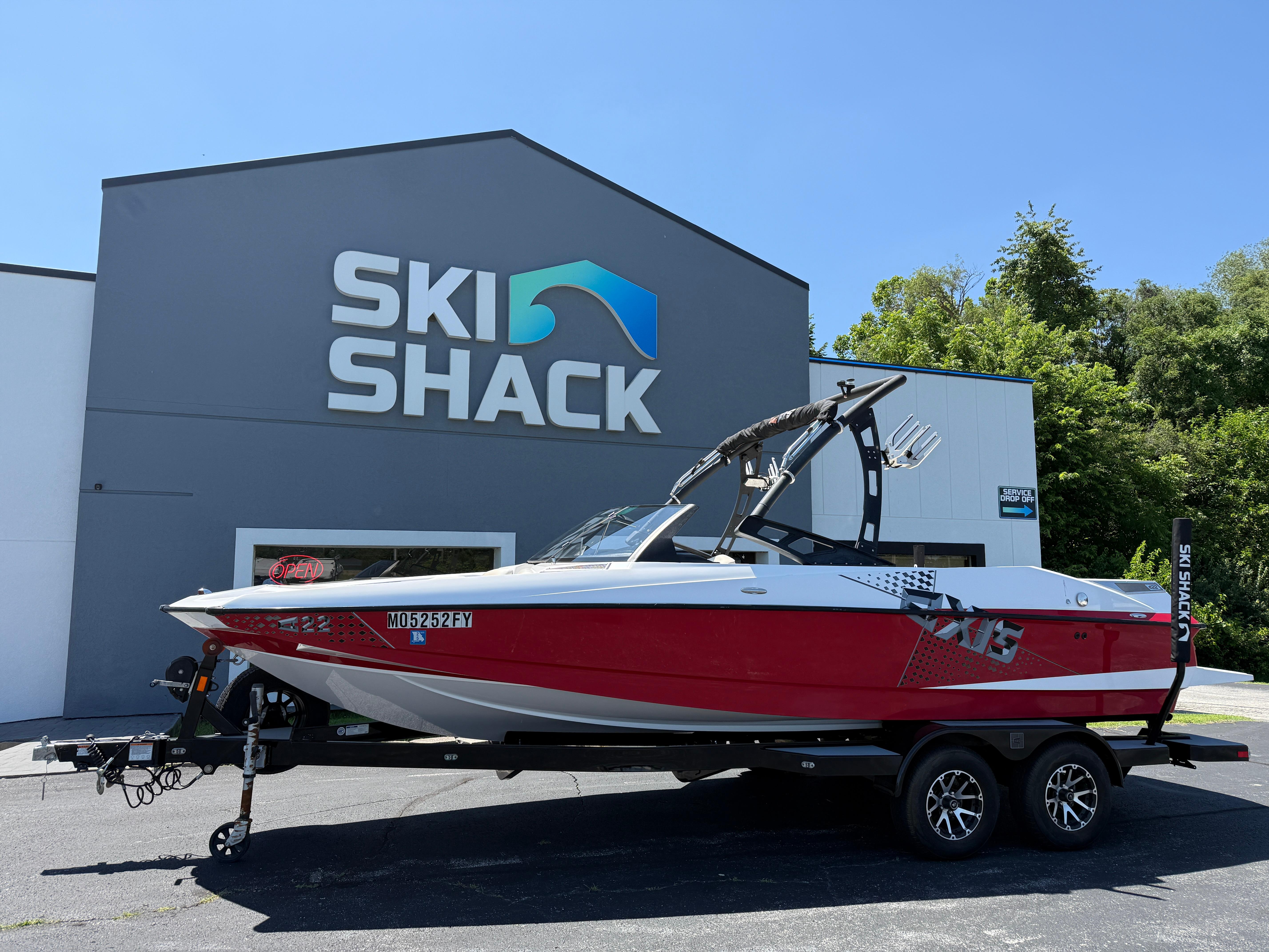 Axis A22 Red 2011 Axis A22 boat on trailer outside Ski Shack building.