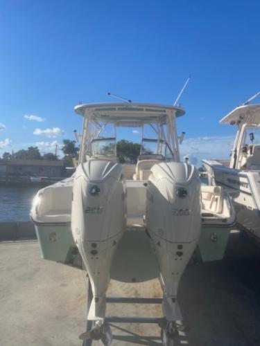 Grady-White Freedom 255 2024 Grady-White Freedom 255 boat with dual engines docked under clear blue sky.