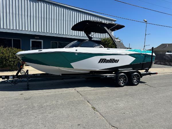 Malibu Wakesetter 23 LSV. 2025 Malibu Wakesetter 23 LSV boat on trailer, parked outdoors.