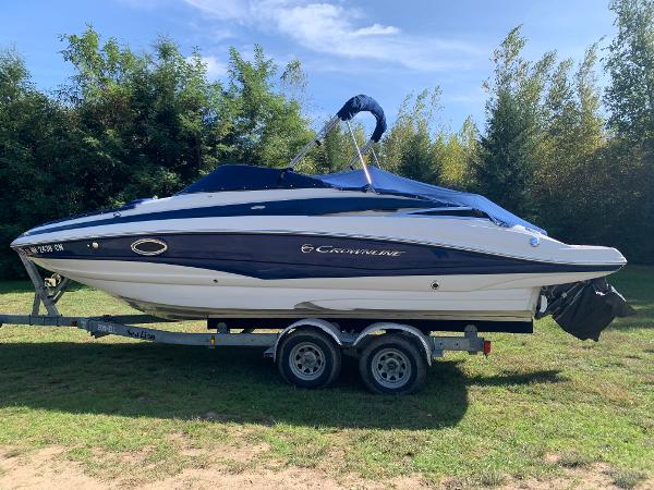 Crownline Eclipse E4 2012 Crownline Eclipse E4 boat on a trailer in a grassy area.