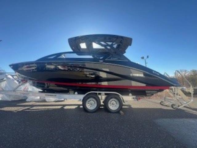 Yamaha Boats 275SD 2025 Yamaha Boats 275SD on trailer, sleek black and red design, outdoor display.