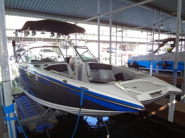 MasterCraft X55 2013 MasterCraft X55 boat docked in a covered marina.