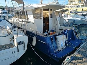 ACM Elite 31 1999 ACM Elite 31 yacht docked at marina, featuring blue hull and white cabin.