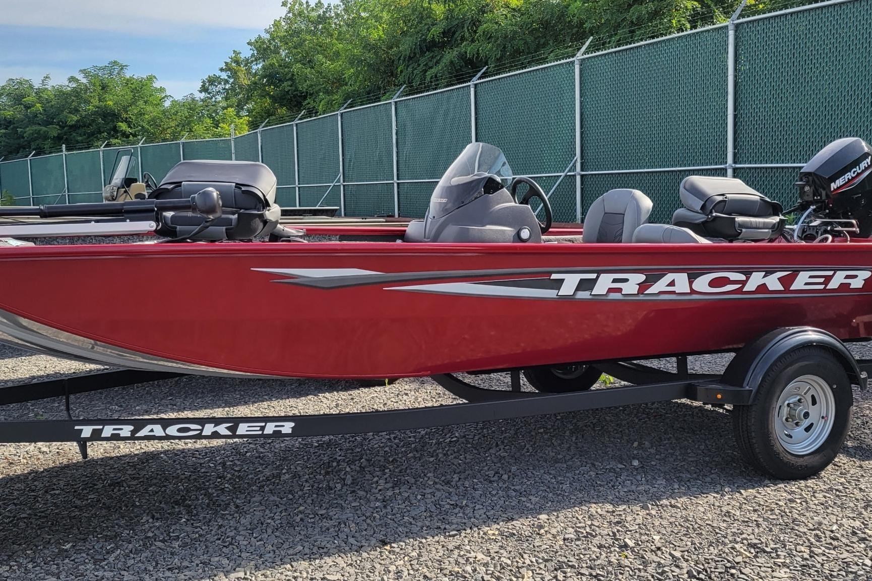 Tracker Pro 170 2025 Tracker Pro 170 boat in red on a trailer, parked outdoors.