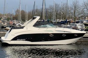 Bayliner 320 Cruiser 2008 Bayliner 320 Cruiser docked in a marina, surrounded by sailboats.