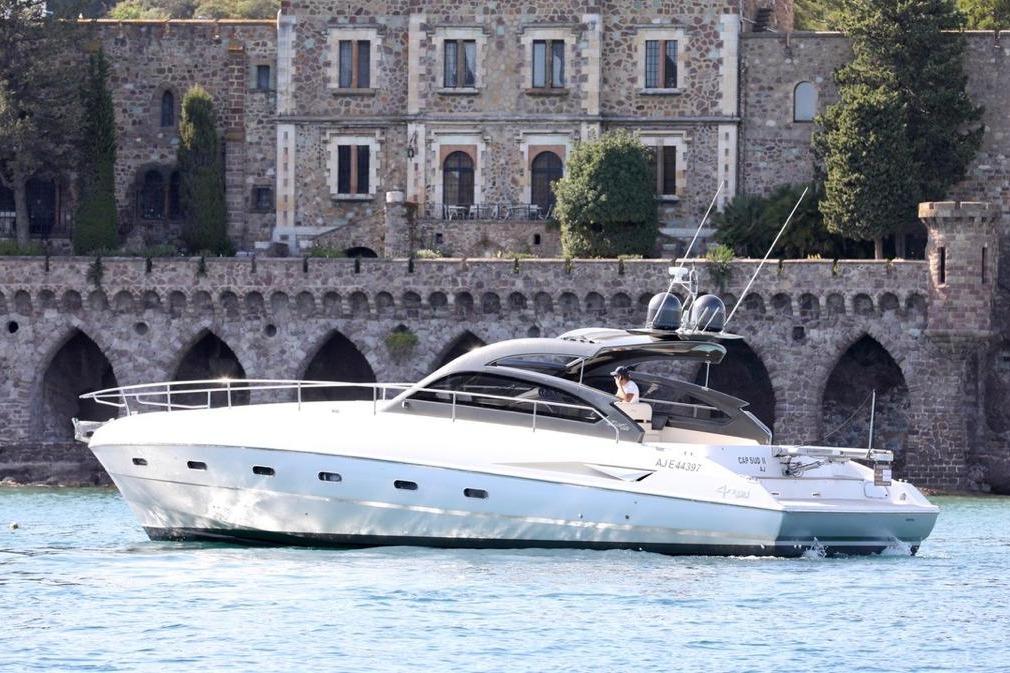 Fiart 47 2010 Fiart Mare 47 yacht cruising near historic stone building.