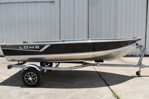Lowe WV1470 2024 Lowe WV 1470 boat on trailer, black and silver design, parked outdoors.