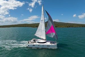 Fountaine Pajot Salina 48 Sailing catamaran Fountaine Pajot Salina 48, 2011 model, cruising on blue waters under clear skies.