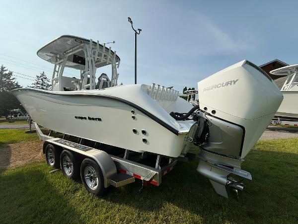 Cape Horn 32 XS 2025 Cape Horn 32 XS boat on trailer with Mercury outboard engine, parked on grass.