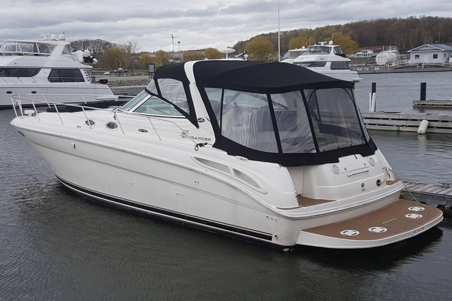 Sea Ray 380 Sundancer 2003 Sea Ray 380 Sundancer yacht docked in a marina, featuring a sleek design and black canopy.