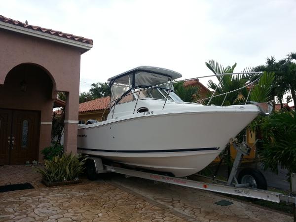 Pro-Line 23 Express 2011 Pro-Line 23 Express boat on trailer beside a house.
