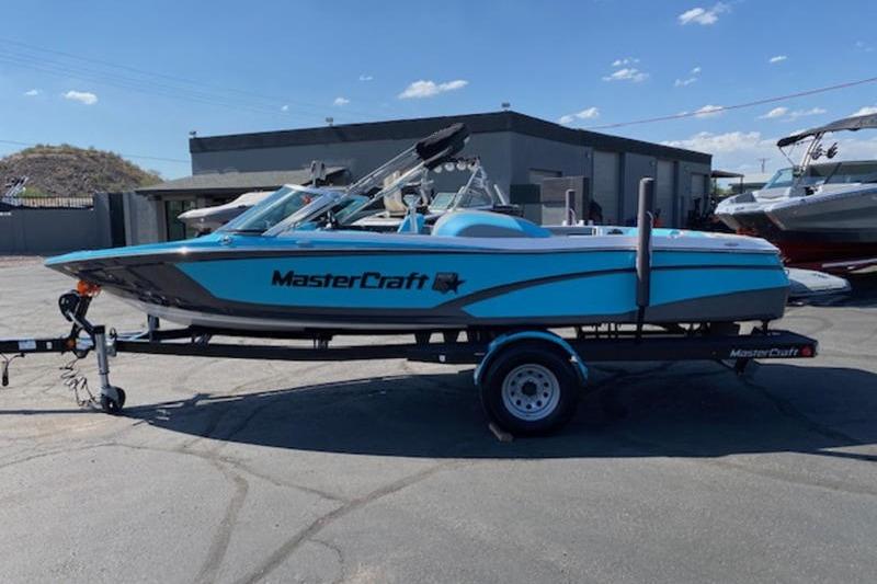 MasterCraft ProStar 2018 MasterCraft ProStar boat on trailer, parked outdoors under clear sky.