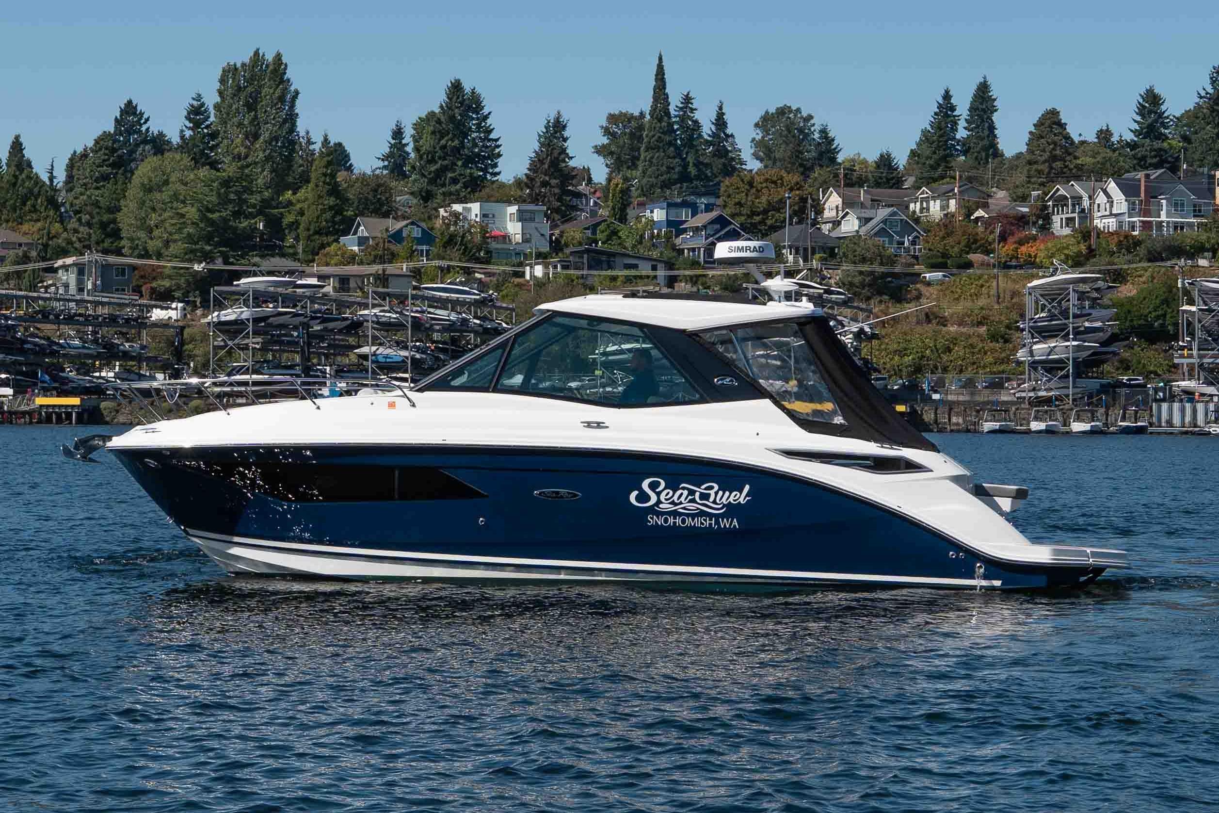 Sea Ray Sundancer 320 Coupe 2023 Sea Ray Sundancer 320 Coupe cruising on a scenic lake with waterfront homes.