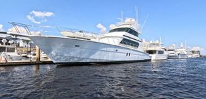 Hatteras 82 1996 Hatteras 82 yacht docked at marina under clear blue sky.