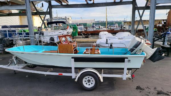 Boston Whaler 16 Sakonnet 1968 Boston Whaler 16 Sakonnet boat on a trailer at a marina.