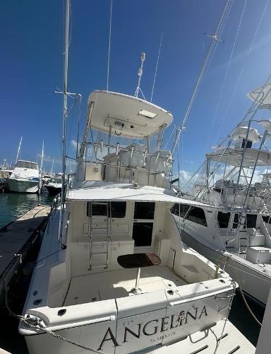 Riviera 37 Convertible 2004 Riviera 37 Convertible yacht docked at marina under clear blue sky.